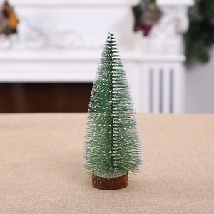Miniature flocked Christmas tree with snowy pine needles and a natural round wooden base