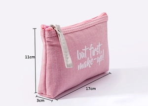 Pink canvas makeup bag showing dimensions 17cm x 11cm x 3cm with side view strap detail