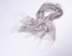 Close-up of silver glitter silk organza scarf featuring elegant tassel fringe detail