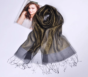Detail of black silk organza scarf featuring gold glitter accents and fringe tassels