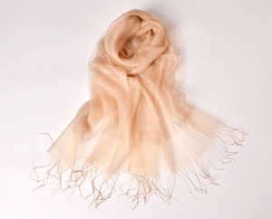 Detail of champagne gold organza scarf with shimmering glitter finish and elegant tassels