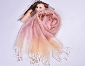 Detailed view of pink gradient silk organza scarf with tassels on fashion magazine