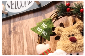 Detailed close-up of a Christmas wreath with plush reindeer and woven rattan texture