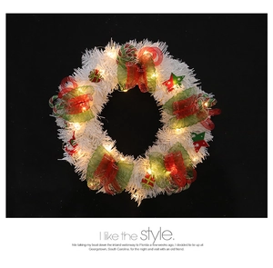 Detail of white Christmas wreath with LED lights, colorful bows and star ornaments