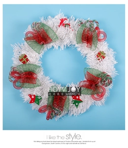 Detail of white Christmas wreath with red reindeer, candy canes, and festive ornaments