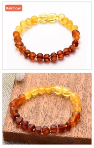 Detail of natural Baltic amber baby bracelet with multicolored gradient beads and screw clasp