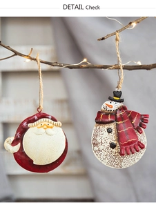Macro detail of retro iron Christmas ornaments with Santa and Snowman on a tree