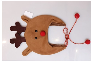 Detail of plush brown reindeer headband with soft antlers and decorative red pom poms