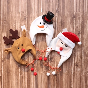 Three plush Christmas hats featuring Santa Claus, reindeer, and snowman on wood background