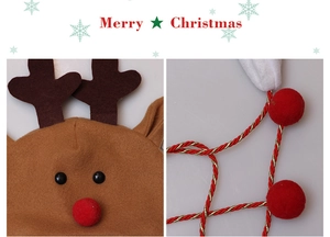 Detail of plush reindeer Christmas hat with brown antlers and red pompom drawstrings