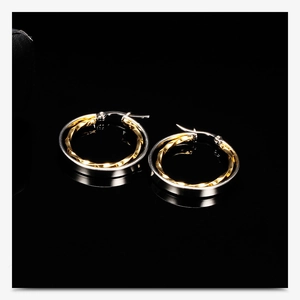 Macro shot of 28mm hollow double-layer round earrings with silver and gold finish