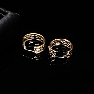 Elegant 304 stainless steel tri-color twisted hoop earrings on a reflective black surface