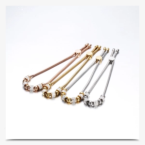 Detailed view of bead bracelets with crystals in rose gold, gold, and silver finishes