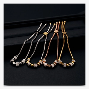 Close-up of four 6mm crystal bead adjustable stainless steel bracelets in a gift box