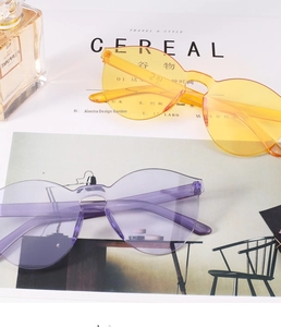 Detail view of rimless oversized sunglasses in bright yellow and light purple colors