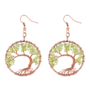 Close-up of handmade bronze wire tree of life earrings with green natural stone beads
