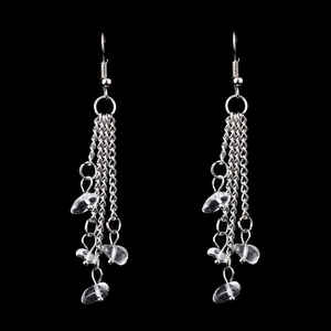 Detail of silver tassel earrings with natural crystal beads and tiered long chain fringe