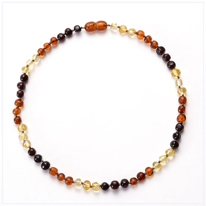 Detailed top view of natural multi-colored amber bead necklace for babies on white background