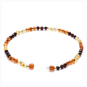 Macro detail of natural multicolored amber round beads with a secure screw clasp closure