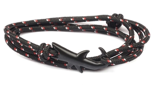 Detail of nautical braided bracelet with a matte black shark-shaped alloy hook clasp