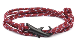 Close-up of tricolor woven rope bracelet featuring a matte black shark metal clasp