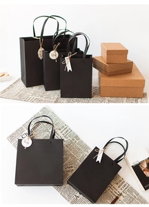 Detail of elegant black paper gift bags with rivet handles and kraft boxes set
