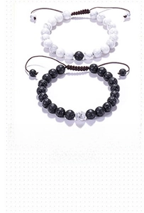 Detailed close-up of 8mm white turquoise and black volcanic stone turtle couple bracelets
