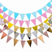 Colorful triangular party bunting banners in gold, rose gold and pastel blue hues