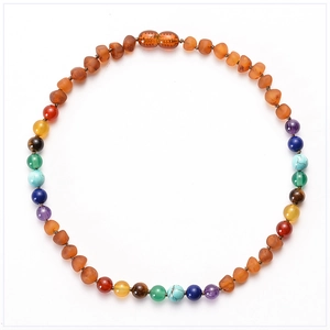 Macro shot of colorful Baltic amber and semi-precious stone beads with hand-knotted details