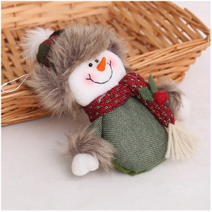Christmas snowman plush pendant in green burlap with knitted scarf in a woven basket