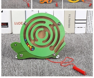 Detail of wooden snail magnetic maze toy with colorful beads and a red stylus pen