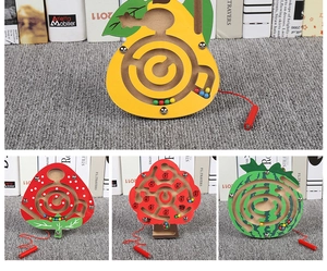 Detail view of four wooden magnetic fruit mazes including apple tree and strawberry designs