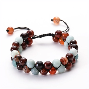 Detail of double-layer hand-woven bracelet with light blue and red brown natural stones