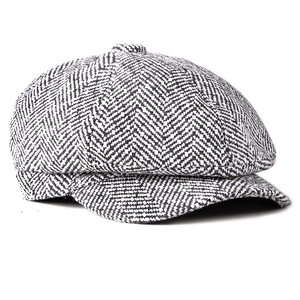 Classic herringbone newsboy cap in black and white knit fabric with a stylish short brim