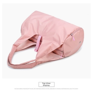 Top view of pink waterproof nylon travel bag with dual handles and secure zip closure