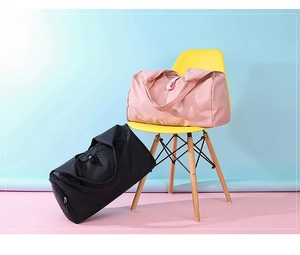 Close-up of pink and black waterproof travel bags with large capacity storage features