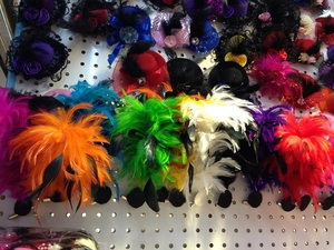Detailed display of colorful feather and flower hair clips with rhinestones and beads