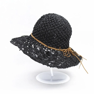 Women's foldable black straw sun hat with woven texture and brown bow detail