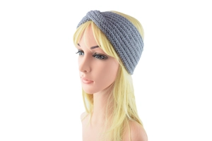 Detail of grey knitted twist headband with chunky woven texture for winter warmth