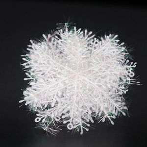 Detailed view of white sparkling snowflake decoration with glitter and laser light effects
