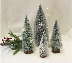 Mini sisal Christmas trees with wooden bases and LED warm string lights on white faux snow