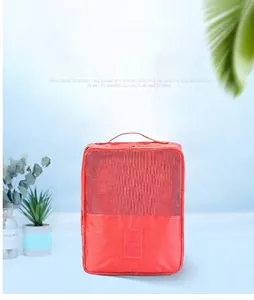 Macro view of coral orange waterproof travel shoe bag with breathable mesh and handle