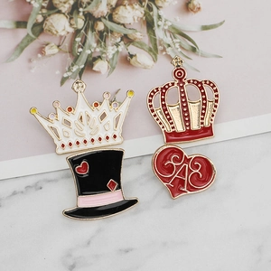 Enamel pin set featuring crown, top hat, and heart designs on marble background