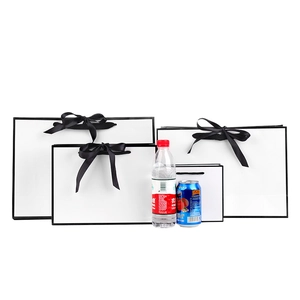 White paper gift bag set with black ribbon handles and elegant trim in three sizes