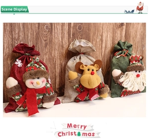 Three burlap Christmas drawstring gift bags featuring 3D snowman, reindeer, and Santa Claus