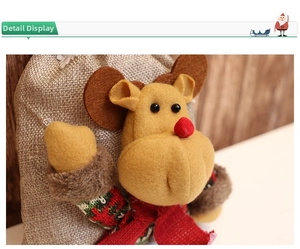 Macro view of Christmas burlap gift bag with a 3D plush reindeer wearing a knit sweater