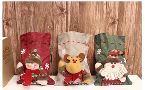 Detail of Christmas burlap drawstring gift bags with 3D plush Santa, Reindeer and Snowman