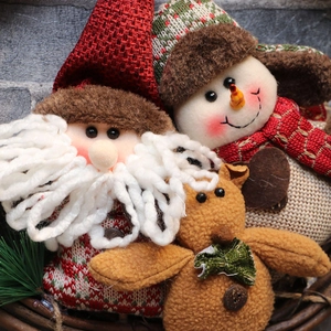 Plush Christmas gnome ornaments including Santa and Reindeer in a rustic woven basket