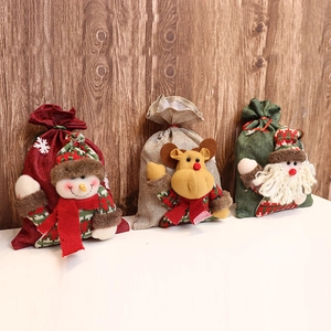 Three Christmas burlap drawstring gift bags with Santa, reindeer and snowman designs
