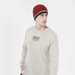 Close-up of knit beanie with red, white, and black striped patterns and logo embroidery